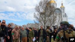 UN Secretary-General Antonio Guterres, fourth left, is seen during his visit to Bucha, on the outskirts of Kyiv, Ukraine, April 28, 2022.