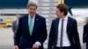 U.S. Secretary of State John Kerry, left, walks to his car with Austria's Foreign Minister Sebastian Kurz, right, as he arrives at Vienna International Airport, in Vienna, Austria, Oct. 15, 2014. 