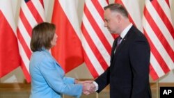 Nan foto sa a ke Biwo Prezidan Poloy la pibliye, Lide La Chanm de Reprezantan Etazini Nancy Pelosi, a goch, bay lanmen ak Prezidan Polone a Andrzej Duda nan Vasovi, Poloy, Lendi 2 Me, 2022. 