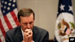 FILE: U.S. Senator Chris Murphy of Connecticut listens during a press conference, April 19, 2022.