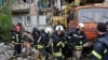 Rescuers carry the body of a civilian at a site of an apartment building destroyed by Russian shelling in Bakhmut, Donetsk region, Ukraine, May 18, 2022.