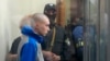 Russian army Sergeant Vadim Shishimarin, is seen behind a glass during a court hearing in Kyiv, Ukraine, May 13, 2022. 