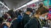 Commuters wearing face masks ride a subway train in Beijing, April 12, 2022. The U.S. has ordered all nonemergency consular staff to leave Shanghai, which is under a tight lockdown to contain a COVID-19 surge.