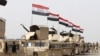 Iraqi security forces ride in vehicles travelling to Mosul to eject Islamic State militants on Feb. 21, 201.6