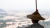 A woman looks out at flooded areas in Naypyitaw, Myanmar, Sunday, Sept. 15, 2024. (AP Photo/Aung Shine Oo)