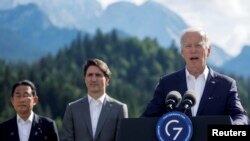 U.S. President Joe Biden speaks next to Japanese Prime Minister Fumio Kishida and Canadian Prime Minister Justin Trudeau during the first day of the G7 leaders' summit at Bavaria's Schloss Elmau castle, Germany, June 26, 2022. 