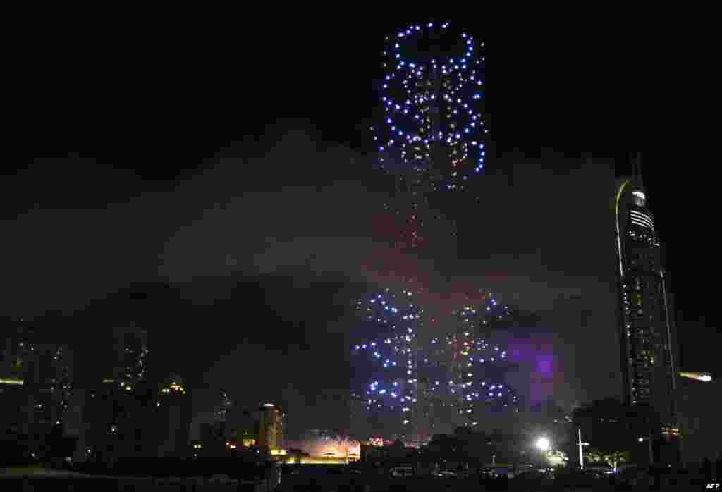 Fireworks explode over Dubai's Burj Khalifa, the world's tallest tower, close to where a huge fire in a luxury hotel injured more than a dozen people hours earlier, during New Year celebrations, Jan. 1, 2016. 