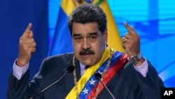 FILE - In this Jan. 22, 2021 file photo, Venezuelan President Nicolas Maduro speaks during a ceremony marking the start of the judicial year at the Supreme Court in Caracas, Venezuela. Maduro said Wednesday, Feb. 17, that he is open to dialogue with…