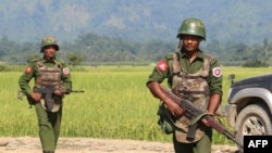 In this photograph taken on October 21, 2016, armed Myanmar army soldiers patrol a village in Maungdaw located in Rakhine State as security operation continue following the October 9, 2016 attacks by armed militant Muslim. - The United Nations called for 