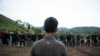 This photo taken on July 7, 2021 shows members of the Karenni People Defense Force (KPDF) taking part in military training at their camp near Demoso in Kayah state. - In their camp hidden in the forested hills of Kayah state near the Thai border, Myanmar. (Photo by STR / AFP) 