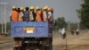 Workers are transported via truck to the site of the Thilawa Special Economic Zone (SEZ) project at Thilawa May 8, 2015. REUTERS/Soe Zeya Tun/File Photo - S1BEUBGAUIAA