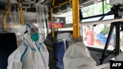 Health workers set up mobile clinic on a bus where people take part in a medical checkup and contact tracing campaign in Yangon on September 9, 2020, as authorities worked to halt the spread of the COVID-19 coronavirus. - Myanmar has seen a sharp rise in 