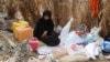 FILE - A Yemeni woman sits in the remains of a home in a neighborhood ravaged by Tropical Cyclone Sagar, in the port city of Hodeidah, Yemen, May 19, 2018