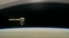 This image made available by NASA in April 2017 shows a still from the short film "Cassini's Grand Finale," with the spacecraft diving between Saturn and the planet's innermost ring. 