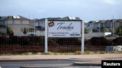 A sign near the Trades housing division built by Gentry Homes promotes special offers for potential buyers in Ewa Beach, Hawaii, March 6, 2013