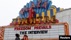 General Manager Brandon Delaney looks up at the marquee sign after the announcement that the Plaza Theatre would be showing the movie "The Interview" beginning Christmas Day in Atlanta, Georgia December 23, 2014. Sony Pictures said on Tuesday it will rel