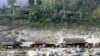  Karen villagers do their routines on the bank of the Salween river 