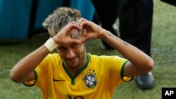 Brazil's Neymar forms a heart with his hands as he leaves the pitch after the World Cup round of 16 soccer match between Brazil and Chile at the Mineirao Stadium in Belo Horizonte, Brazil, Saturday, June 28, 2014. Brazil won 3-2 on penalties after the mat