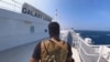 Houthi fighter stands on the Galaxy Leader cargo ship in the Red Sea