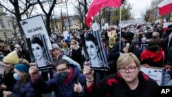 Protesters gather outside Poland's Constitutional Tribunal in Warsaw, Nov. 6, 2021, rallying against restrictive abortion laws after a woman died of complications during her pregnancy. 