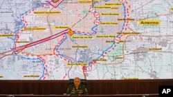 FILE - Lt. Gen. Sergei Rudskoi of the Russian military's General Staff speaks, in front of a map of the Aleppo area in Syria, at a briefing at the Russian Defense Ministry's headquarters in Moscow, Russia, Oct. 19, 2016.