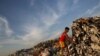 A boy looks for recyclable waste at a rubbish dump outside Yangon January 7, 2016. REUTERS/Soe Zeya Tun - RTX21FSN