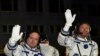 U.S. astronaut Scott Kelly, left, and Russian cosmonaut Gennady Padalka, crew members of the mission to the International Space Station, ISS, wave prior to the launch of Soyuz-FG rocket at the Russian-leased Baikonur cosmodrome, Kazakhstan, March 27, 201