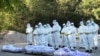 SENSITIVE MATERIAL. THIS IMAGE MAY OFFEND OR DISTURB Volunteers carry bodies of people who died due to the coronavirus disease (COVID-19), during their funeral at a cemetery in Mandalay, Myanmar July 14, 2021. REUTERS/Stringer