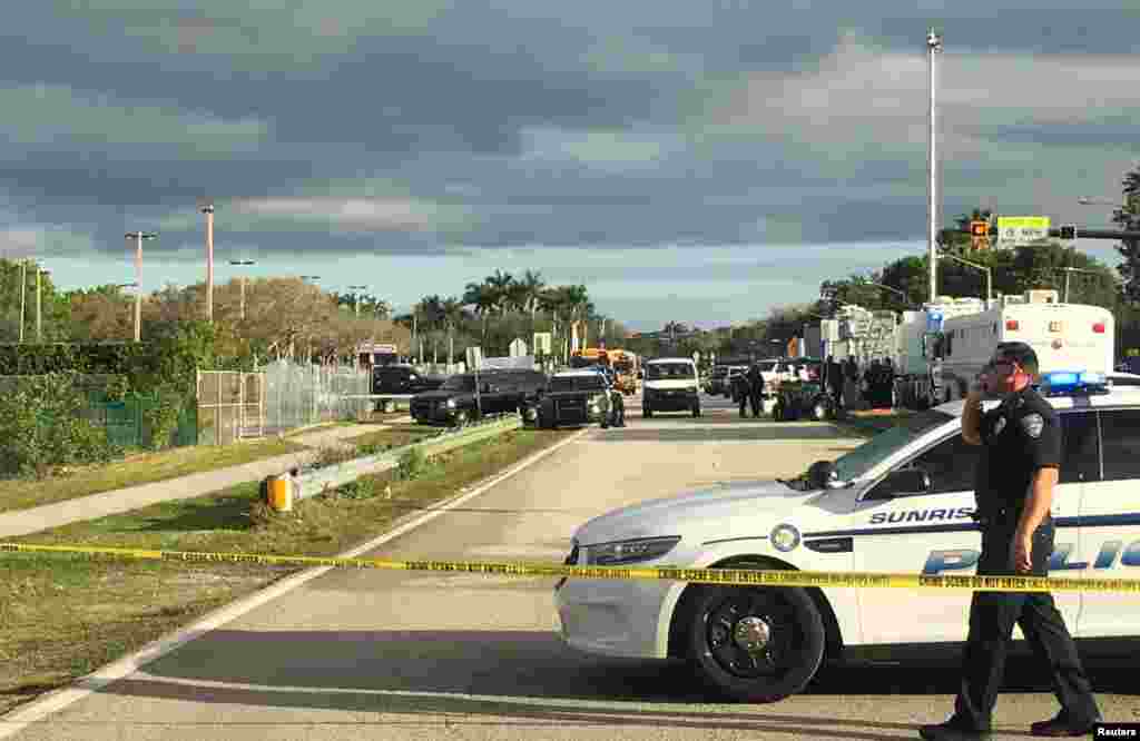 Police patrol the area outside Marjory Stoneman Douglas High School following a school shooting incident in Parkland, Florida, Feb. 15, 2018.