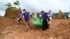 Myanmar soldiers and Red Cross workers carry out a body recovered from the site of a landslide by jade mines near Hpakant in Kachin state on July 4, 2020. - Dozens of jade miners have been buried in a mass grave after a landslide in northern Myanmar kille