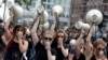 Women hold up megaphones during a protest against the G-20 summit in Hamburg, Germany, July 8, 2017. 