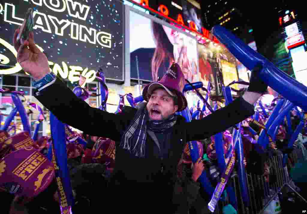 A reveler takes a photo of himself during the annual New Year's Eve celebration in Times Square on Thursday, Dec. 31, 2015.