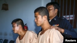 Myanmar migrant workers Zaw Lin (L) and Win Zaw Htun (R) leave after hearing the verdict at the Koh Samui provincial court in Koh Samui, Thailand, December 24, 2015. A Thai court sentenced the two Myanmar migrant workers to death on Thursday after convict