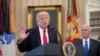 President Donald Trump, accompanied by Vice President Mike Pence, right, speaks during a signing ceremony for executive orders regarding trade in the Oval Office at the White House, March 31, 2017, in Washington. 