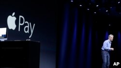 FILE - Craig Federighi, Apple senior vice president of Software Engineering, speaks about Apple Pay at the Apple Worldwide Developers Conference event in San Francisco, June 8, 2015.