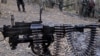 Karen National Union (KNU) soldiers stand guard with their assault weapons at Oo Kray Kee village in Karen State near Thai-Myanmar border on January 30, 2012. The Karen National Union (KNU) is waging the world's longest-running insurgency, launched 63 yea