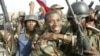 aitian National Revolutionary Liberation Front Commander-in-Chief, Guy Philippe, hugs other soldiers from the 