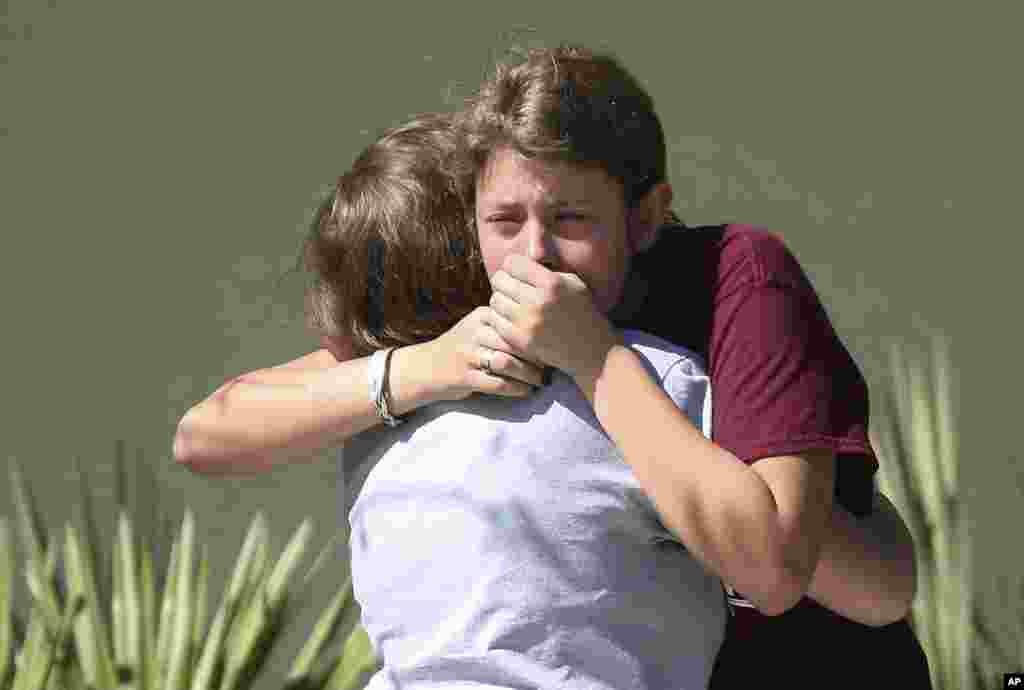 Students grieve outside Pines Trail Center where counselors are present, after Wednesday's mass shooting at Marjory Stoneman Douglas High School in Parkland, Florida, Feb. 15, 2018.