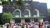 In this photo taken on Oct. 2, 2005, graduated students and family members gather outside the convocation hall in the main campus of Yangon University during a graduation ceremony in Yangon, Myanmar. The university was once one of Asia's finest and a poig