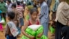 A newly arrived Rohingya girl carries food rations in Kutupalong, Bangladesh, Saturday, Sept. 30, 2017. 