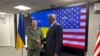 Ukrainian Defence Minister Rustem Umerov (L) greets United States Secretary of Defense Lloyd Austin prior to their talks in Kyiv on November 20, 2023. (Photo by W.G. DUNLOP / POOL / AFP)